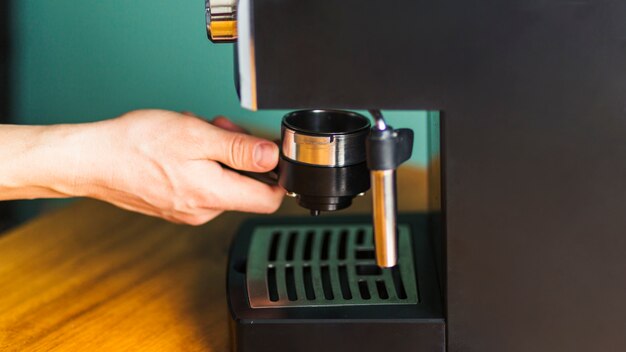 Hand installing filter in espresso machine