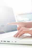 Free photo hand on keyboard and point to screen of laptop, business concept with copy space