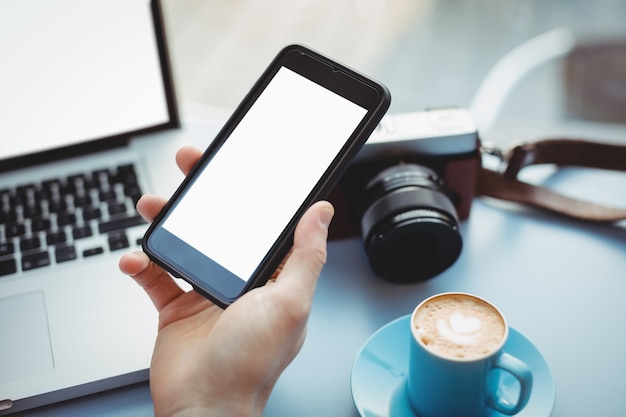 Hand of male executive holding mobile phone