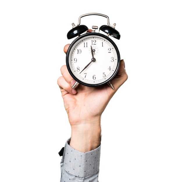 Hand of man holding vintage clock