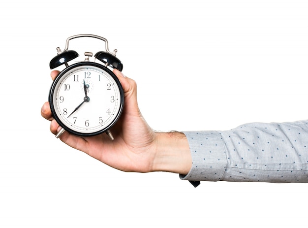 Hand of man holding vintage clock