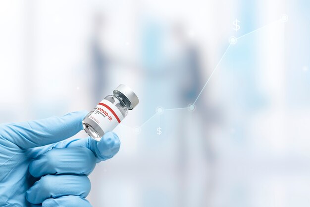 Hand in medical glove holding a vaccine vial