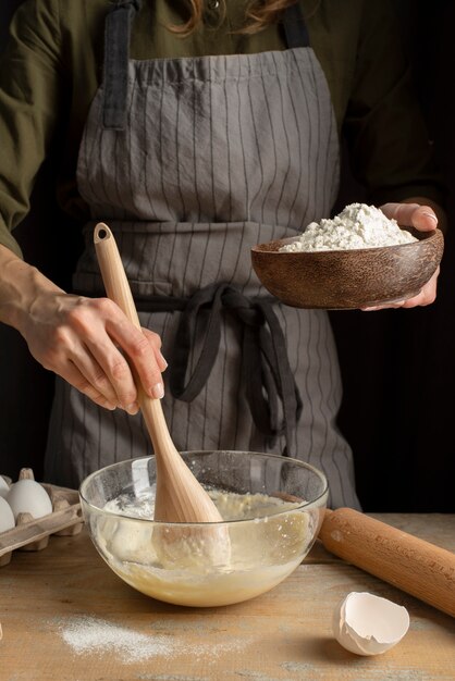 Hand mixing dough close up