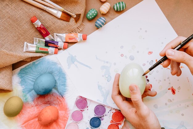 Hand painting egg with brush