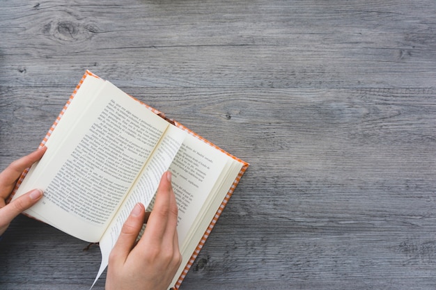 Hand passing the page of a book