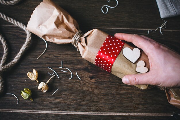 Hand picking brown candy-shaped bag