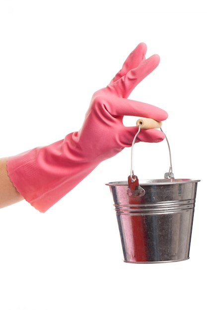 Hand in a pink glove holding silver pail 