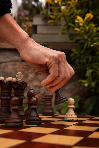 Free photo hand playing chess on classic board