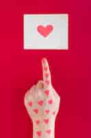 Free photo hand pointing finger at heart drawing