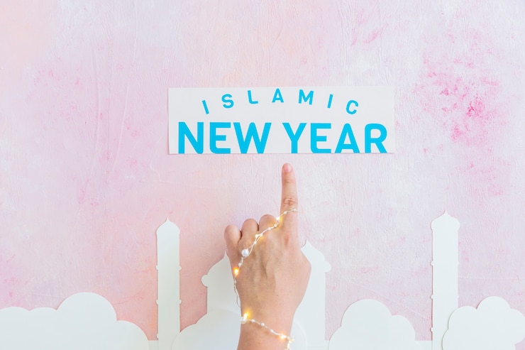 Free Photo hand pointing at islamic new year inscription