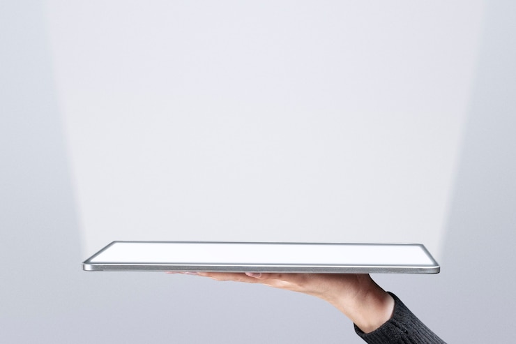 Free Photo hand presenting invisible hologram projecting from tablet advanced technology