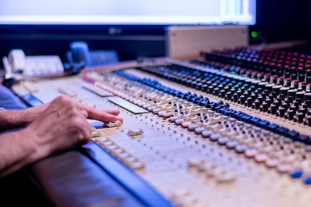 Hand pushing buttons on a soundboard