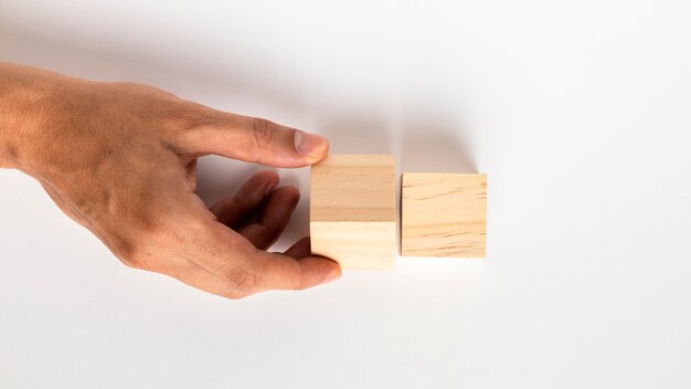 Hand rotating small wooden cube