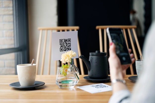 Free photo hand scanning qr code with phone