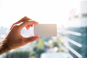 Free photo hand showing a blank business card