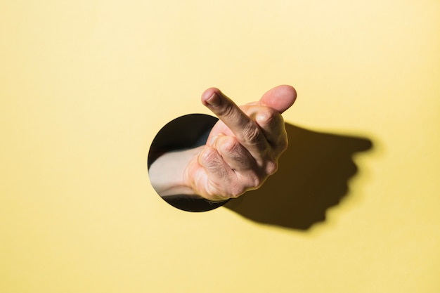 Free Stock Photo: Hand Showing Middle Finger Through Background