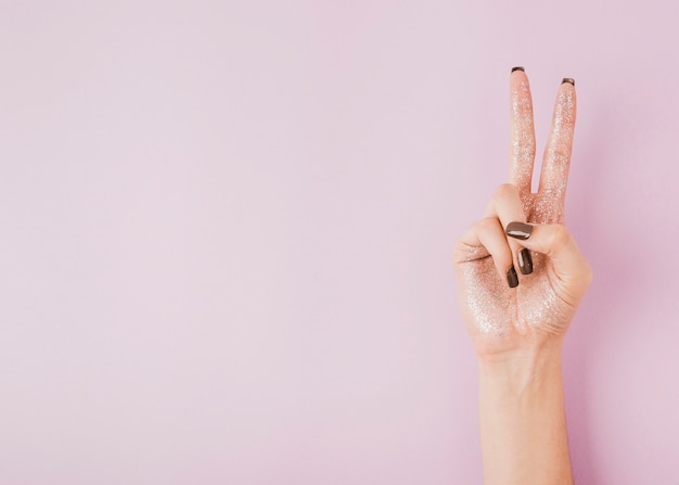 Free photo hand showing peace sign on copy space background
