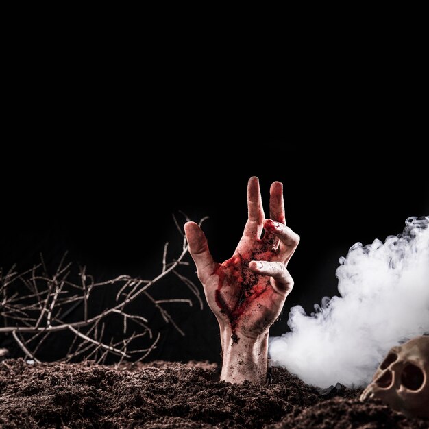 Hand sticking out of ground near heavy fog 