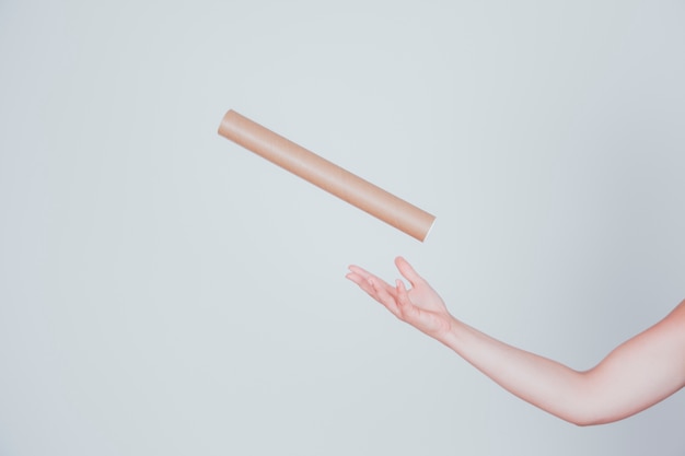 Free photo hand throwing tube in air