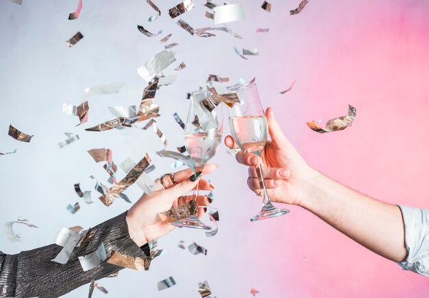 Hand toasting with confetti