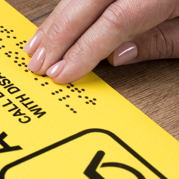 Hand touching braille words