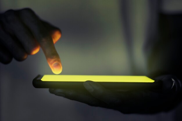 Hand touching illuminated smartphone screen