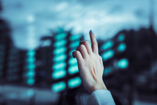 Hand touching a transparent digital screen