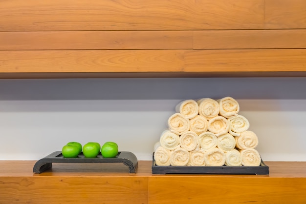 Hand towel in fitness club with green apple .