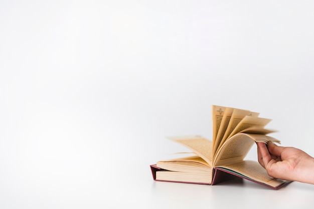 Hand turning pages of book 