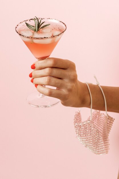 Hand wearing mask and holding drink close up