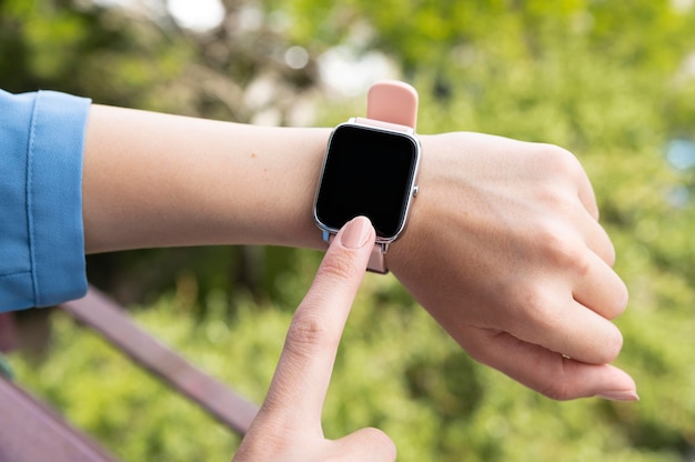 Hand wearing smartwatch close up