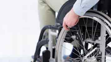 Free photo hand on wheelchair wheel close-up