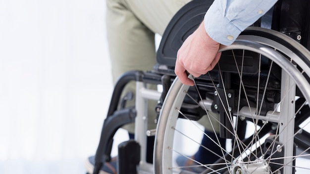 Hand on wheelchair wheel close-up