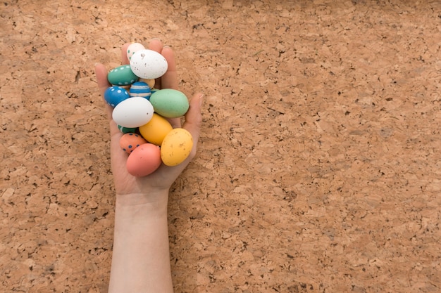 Hand with colored eggs for easter day