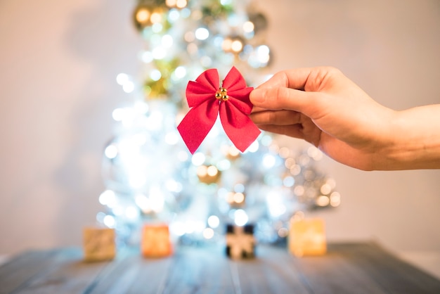 Hand with decorative bow 