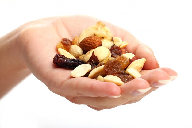 Hand with different dried fruits