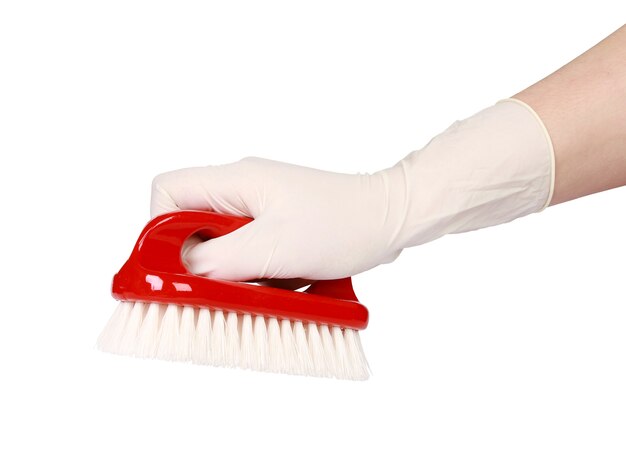 Hand with a glove holding a red brush isolated on white background