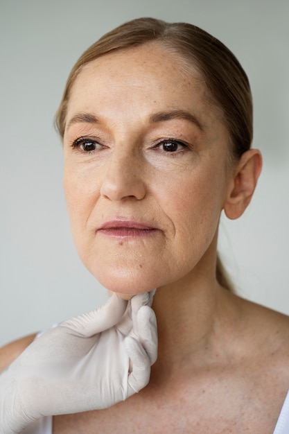 Free photo hand with glove holding woman's skin