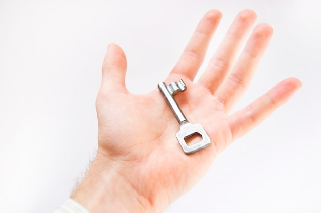 Free photo hand with a key in white background