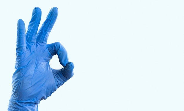 Hand with latex glove showing ok sign