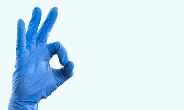 Hand with latex glove showing ok sign