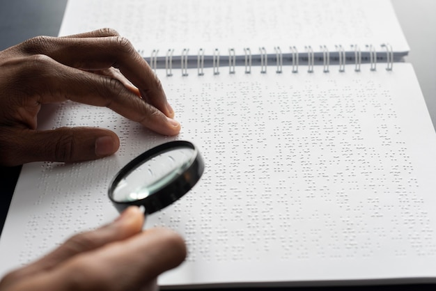 Hand with magnifying glass close up