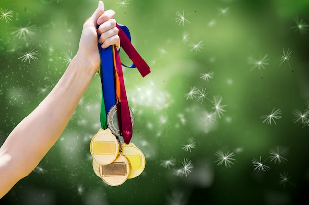 Free photo hand with many medals