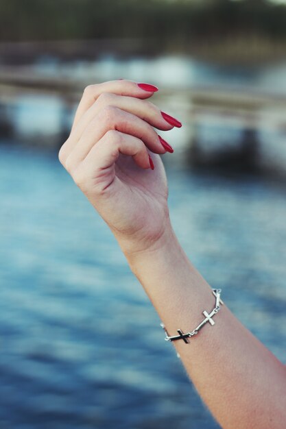 Hand with painted nails and a bracelet