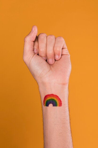 Hand with painted rainbow