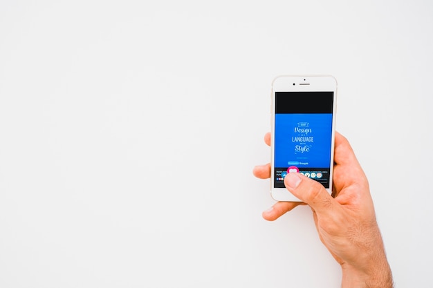 Hand with phone pressing like button in facebook with copy space
