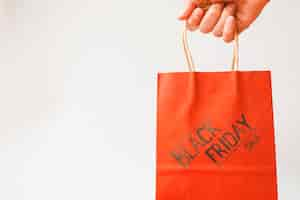 Free photo hand with red shopping bag