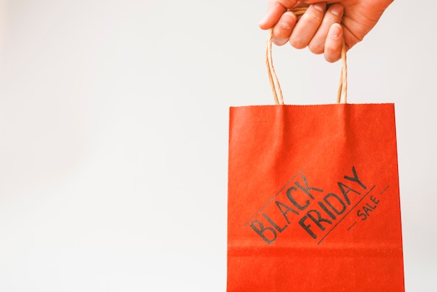 Hand with red shopping bag