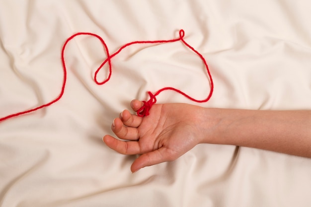 Hand with red thread
