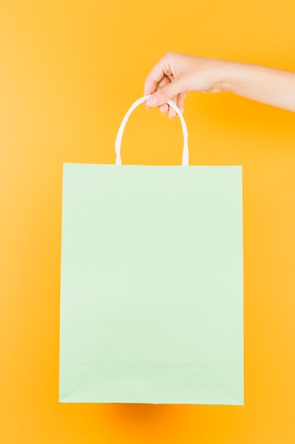 Hand with salad shopping packet